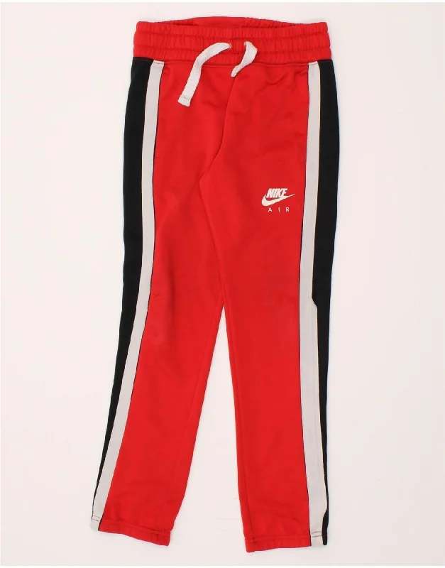 Light Dressing NIKE Boys Tracksuit Trousers 10-11 Years Medium Red Colourblock Polyester